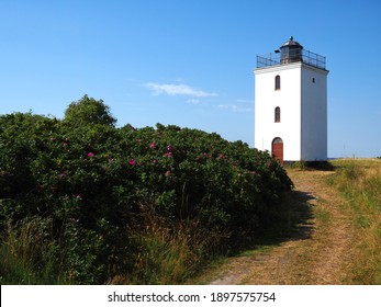 Small old traditional lighthouse landmark and toursit attraction on the coast Baagoe Bågø Island Funen Denmark