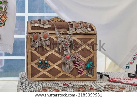 Small old vintage chest for traditional Tatar jewelry. National retro necklace and earrings made of metal and semi-precious stones. Folk festival Sabantuy