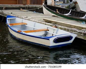 Small Old Wooden Boats Docked On The Gang Plank Of The Pier