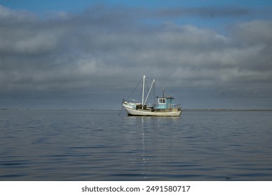 a small old wooden fishing boat on baltic sea calm water. - Powered by Shutterstock