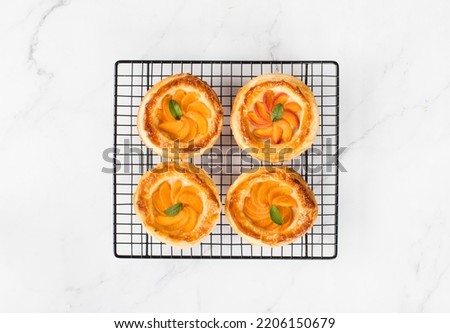 Similar – Puff pastry biscuits with nectarines, camembert and thyme