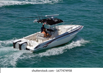 
Small open white fishing boat with center console cruising the Florida Intra-Coastal Waterway off Miami Beach.