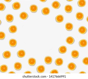 A Lot Of Small Orange Cut In Half On A Light Blue Background With Large Size Shadows In The Middle Is Empty For Writing.