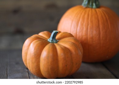 Small Orange Pumpkins On Rustic Barnwood Table