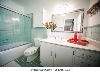 Small Outdated Tile Bathroom With A Clear Glass Door And A White Cabinet Sink Vanity And Mirror