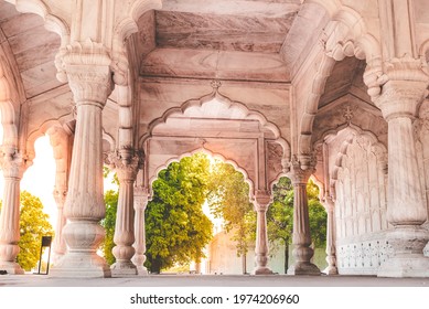 Small palace at the Red fort of Delhi, India. A shining white marble palace with cylindrical pillars and arches in traditional Mughal pattern of architecture.