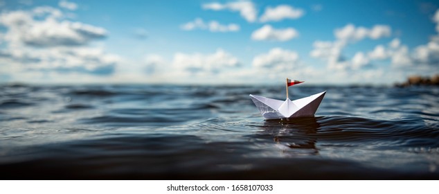 Small Paper Boat In Big Waves