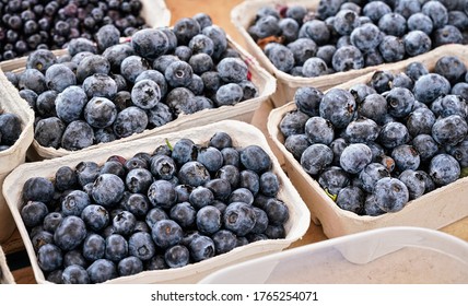 Small paper boxes with blueberries displayed on food market, closeup detail - Shutterstock ID 1765254071