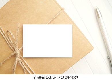 Small paper card mockup on gift box for design presentation, business, gift, shop or Thank you card.