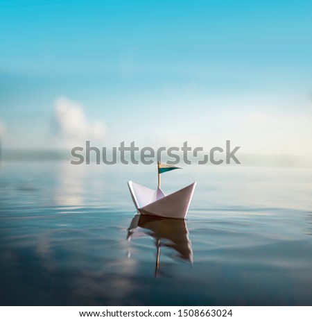 Small Paper Ship floating on Water