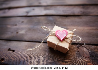 Small Parcel Tied Up By Thread With Pink Heart On Its Top