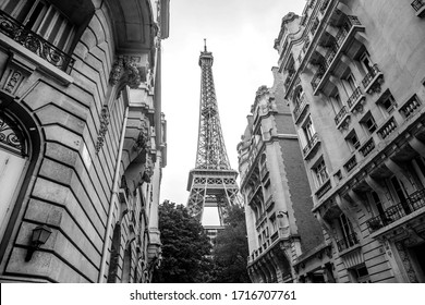 Small Paris Street With View On The Famous Eiffel Tower On A Cloudy Rainy Day In Black And White