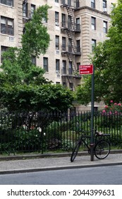 Small Park Along A Street In Greenwich Village With An Old Apartment Building In New York City