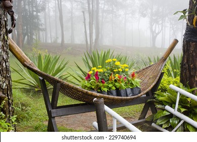 Small Park Decorate With Colorful Flowers And Rattan Container. Garden Design And Decoration.