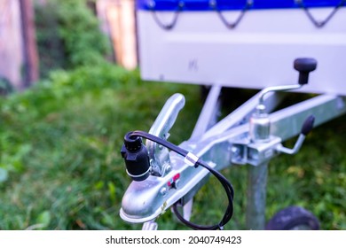 Small parked luggage trailer close up shot, focus on the electrical connection, space for text.