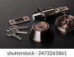 Small parts of Deadbolt lock to protect security safety on door window house. Incomplete many parts of deadbolt lock before assemble to door window with key over black background