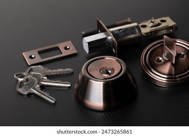 Small parts of Deadbolt lock to protect security safety on door window house. Incomplete many parts of deadbolt lock before assemble to door window with key over black background