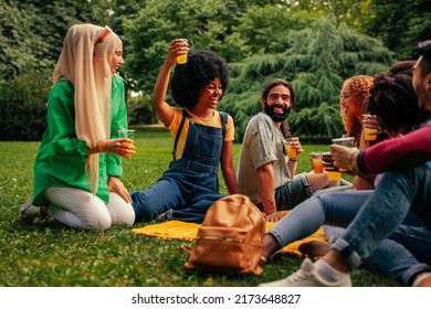 A Small Party Of Multiethnic Friends Are Reunited After Long Covid19 Lockdowns In The Community Park For A Picnic