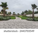 Small path between the landscaping area. Center medium interlock path between the plants and trees.
Walking Pathway between the Washingtonia Palm tress 