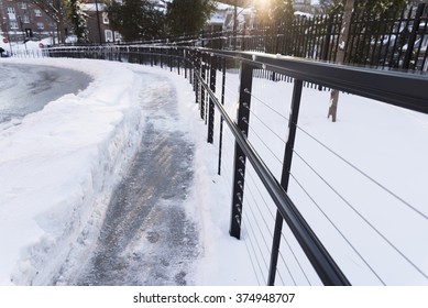 small pathway covered by deep snow on the way down to the street