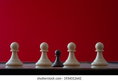 small pawn on chess board against larger adversary concept of adversity ,discimination ,equality .