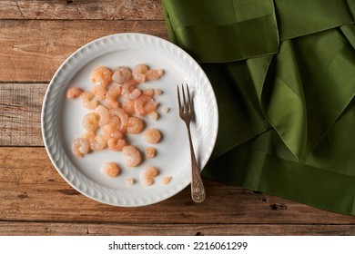 Small Peeled Prawns On A Plate And Rustic Wooden Table