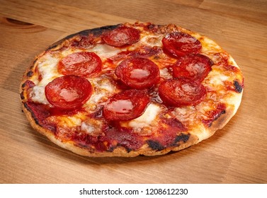 Small Pepperoni Pizza On A Wooden Table