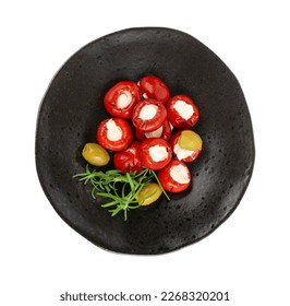 Small Peppers Stuffed with Cheese, Cherry Pepper Filled Feta, Cream Cheese, Pickled Olives, Herbs, Vegetable Antipasti on Black Plate