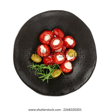 Small Peppers Stuffed with Cheese, Cherry Pepper Filled Feta, Cream Cheese, Pickled Olives, Herbs, Vegetable Antipasti on Black Plate