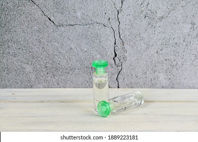 A small perfume bottle on an old wooden table, perfect for background and water use.