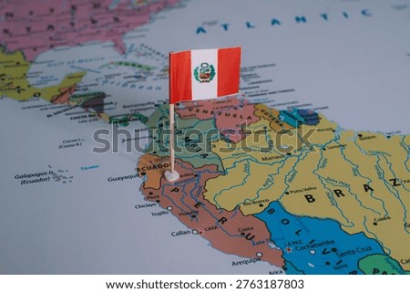 A small Peruvian flag pin placed on a map of South America, representing upcoming national elections and the democratic voting process in Peru.