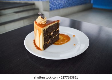 Small Piece Of Brown Sugar Cake Dish On Black Table And White Plate