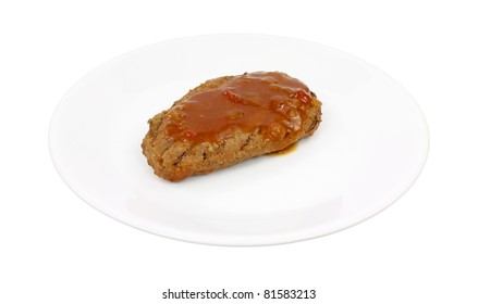 A Small Piece Of Meatloaf With Gravy On A White Plate.