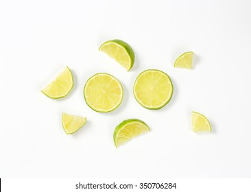 small pieces of fresh lime on white background