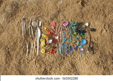 Small pieces of plastic found at the beach are arranged in a colorful way. 