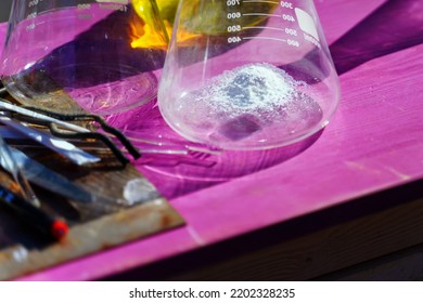 A Small Pile Of White Powder Lies In A Chemical Flask