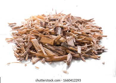 Small Pile Of Wood Chips For Heating Industrial Boilers Isolated On A White Background. Raw Material Sample Close Up