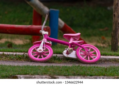 Small Pink Bycicle For Kids Lying On The Floor.