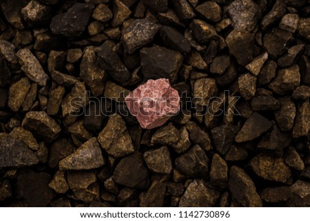 A small pink granite stone lies among a heap of identical cramps,
separate stones of no value, but only one mass.
The only stone is a symbol of individuality. It are used in construction and interior.
