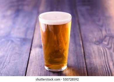 Small Pint Of Lager On A Wooden Table