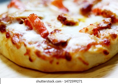 Small Pizza With Mozzarella Cheese, Sausage, Ham,crab Stick, On Wooden Background.