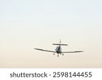 small plane in the air. concept in articles and advertising materials related to aviation, air travel, private jets and flight school.