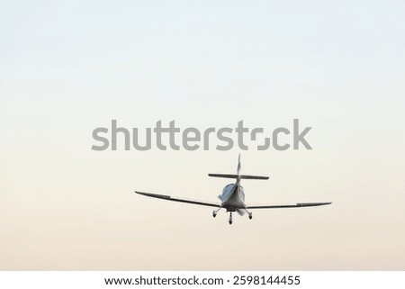 small plane in the air. concept in articles and advertising materials related to aviation, air travel, private jets and flight school.