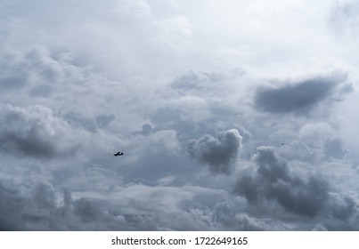 Small plane in cloudy sky for rainmaking. White fluffy clouds with small aircraft to make artificial rainfall. Two airplane flying on cloudy sky. Agricultural airplane for artificial precipitation.