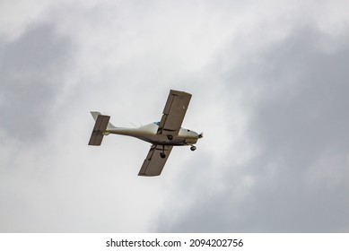 A Small Plane Flies In The Sky