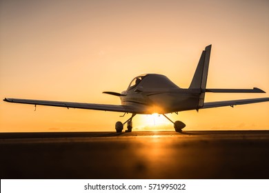 Small Plane On The Runway At Sunset Background