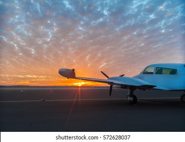 Small Plane On The Runway At Sunset Background