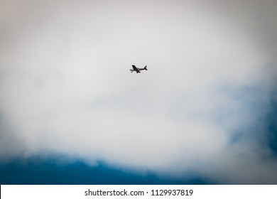 Small Plane In Sky With Cloud