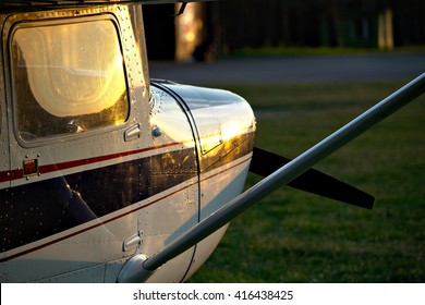 Small Plane At Sunset.