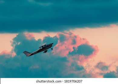 Small Plane Taking Off On Sunset Sky Background